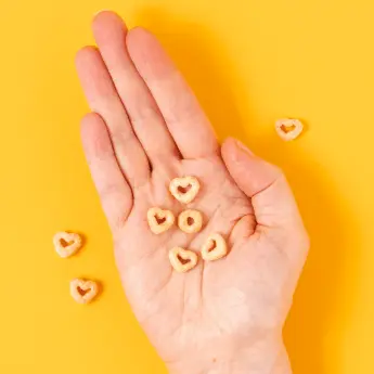 Instagram post featuring heart-shaped Cheerios in an open hand. - Link to social post