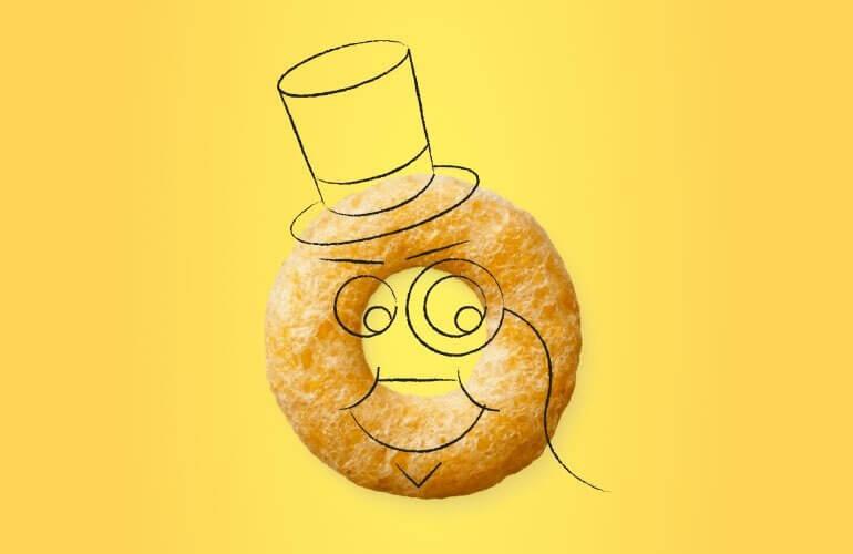 A single Cheerio with a smiling face, top hat, and monocle on a sunny yellow background
