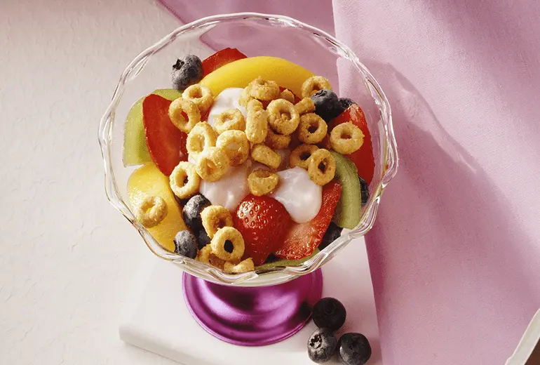 Overhead view of a parfait made with bananas, yogurt and whole grain Cheerios cereal.