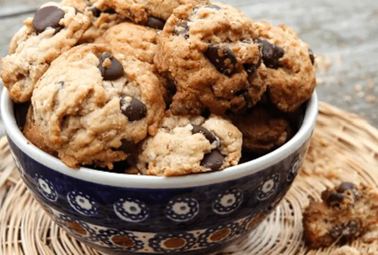 Chocolate chip cookies made with Cheerios and Betty Crocker Bisquick Gluten Free mix filling a bowl.