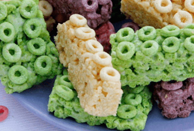 Blocks of Fruity Cheerios and melted marshmallows piled onto a plate.